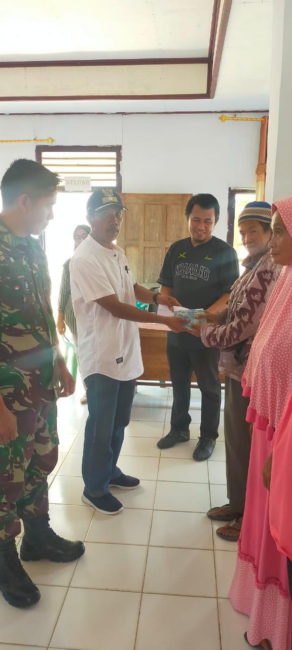 Penyerahan BLT oleh Kades Kokini bersama Babinsa Serda Rifael di kantor BPU Kokini, Kamis (30/3/2023). FOTO: DOK PEMDES KOKINI