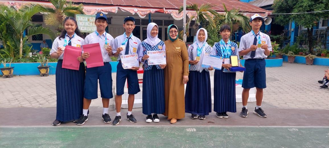 FOTO bersama Kepsek dan ketujuh peserta didik SMPN 2 Palu, yang berhasil meraih prestasi, usai pelaksanaan upacara bendera, Senin (20.3.2023). FOTO: IST