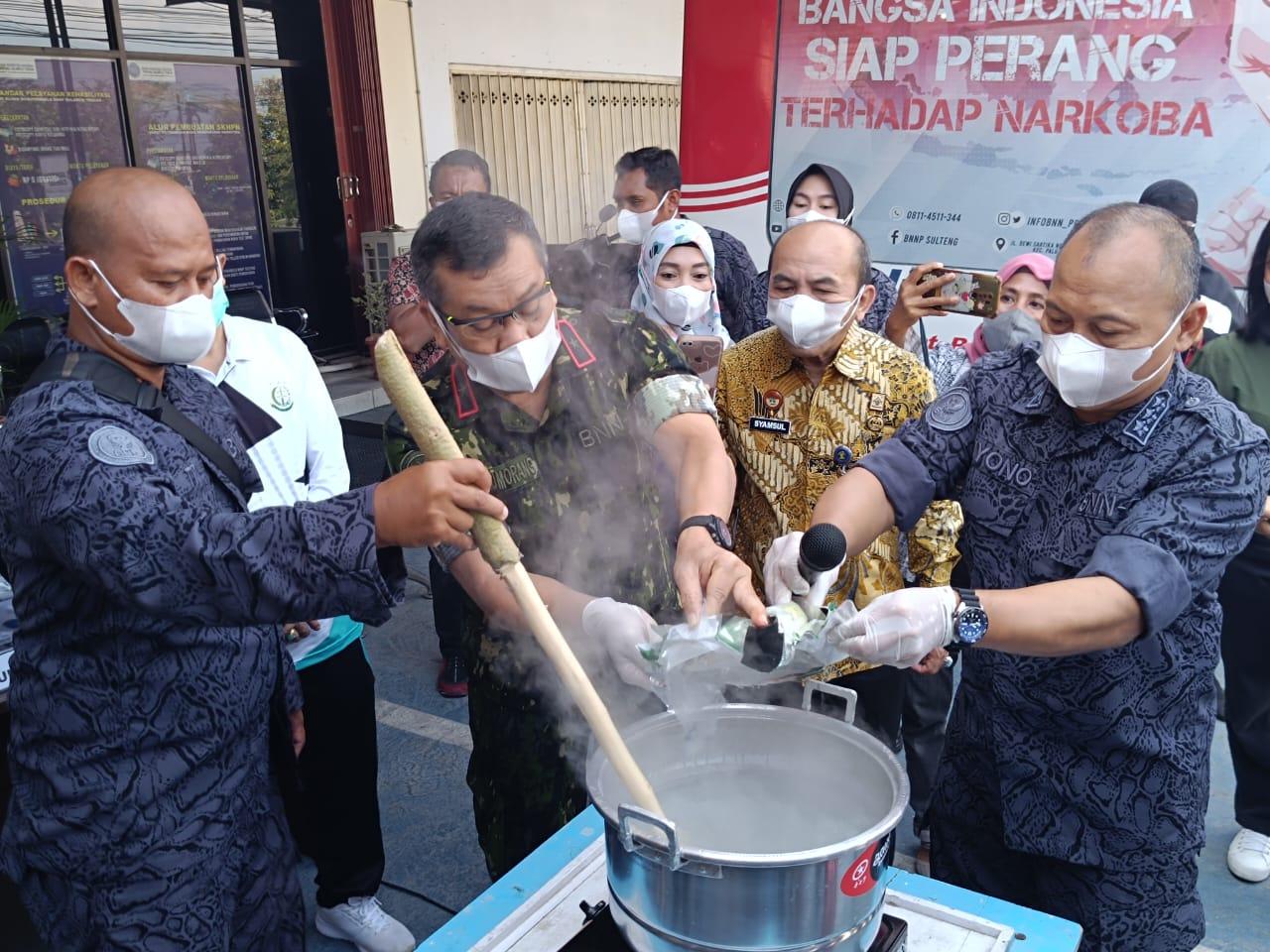 FOTO: Kepala BNNP Sulteng, Brigjen. Pol. Monang Situmorang (kedua dari kiri) saat merebus barang bukti hasil penangkapan di depan Kantor BNNP Sulteng, Jalan Dewi Sartika, Kota Palu, Jumat (4/8/2023). FOTO: RAHMAT KURNIAWAN